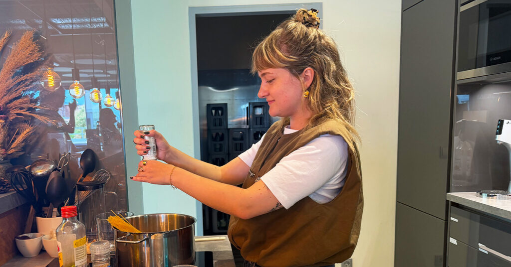 Person cooking in a kitchen, reflecting the idea of combining elements into a digital marketing strategy.