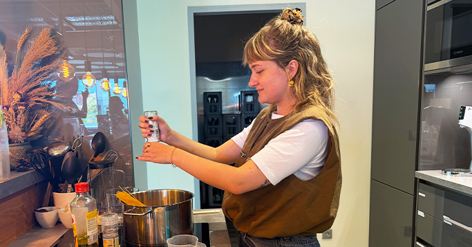 Person cooking in a kitchen, reflecting the idea of combining elements into a digital marketing strategy.
