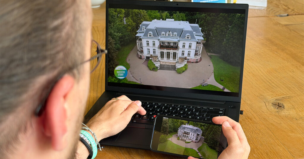 Person watching the same video of a villa on laptop and smartphone, demonstrating hyper-personalized cross‑device experiences.