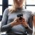 Three people three woman looking at their phones iphone smartphones